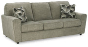 Ashley Furniture Cascilla living room set with plush sofa and armchair, shown from an angled side view in a modern living space.