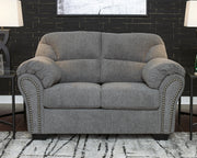 Ashley Furniture Allmaxx loveseat with plush fabric and cushioned armrests, shown in a cozy living room setting.