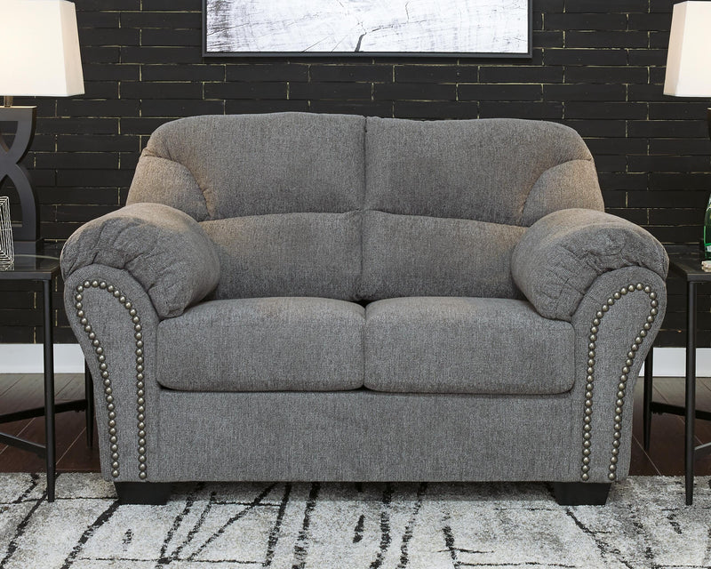 Ashley Furniture Allmaxx loveseat with plush fabric and cushioned armrests, shown in a cozy living room setting.