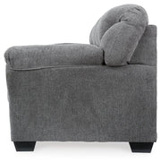 Ashley Furniture Allmaxx sofa shown from the side with plush cushions and wooden legs, modern living room furniture piece.
