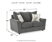 Ashley Furniture Stairatt living room set with sofa and armchair in a modern design, featuring neutral upholstery and wooden legs.