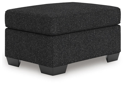 Ashley Furniture Jasmine Peaks Ottoman with plush fabric and wooden legs, shown from a slight angle.