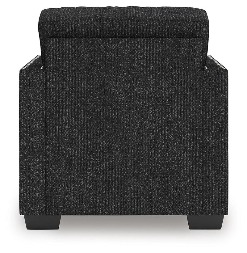 Jasmine Peaks Ashley Furniture chair with plush fabric upholstery and wooden legs, shown from the back.