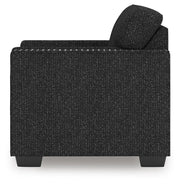 Ashley Furniture Jasmine Peaks Chair with wooden armrests and plush beige upholstery, shown from the side.