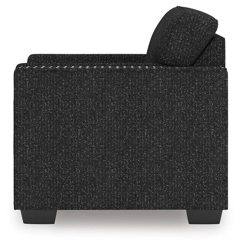 Ashley Furniture Jasmine Peaks Chair with wooden armrests and plush beige upholstery, shown from the side.