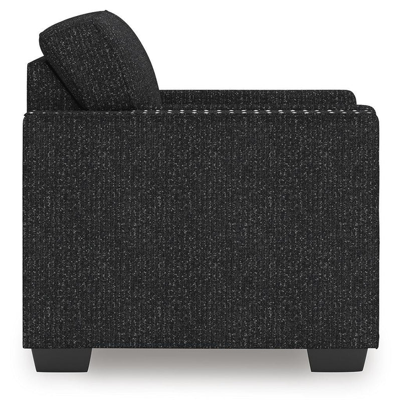 Ashley Furniture Jasmine Peaks chair with plush fabric and wooden legs, shown from the side angle.