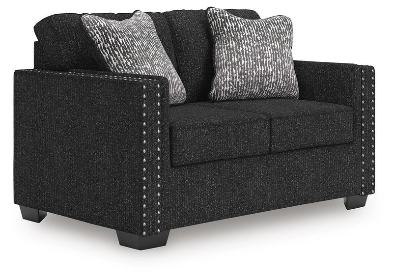 Ashley Furniture Jasmine Peaks loveseat with plush fabric and cozy cushions, viewed from an angled side perspective.