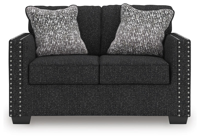 Ashley Furniture Jasmine Peaks loveseat with plush beige upholstery and cushioned armrests, shown from a front head-on angle.