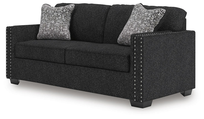 Ashley Furniture Jasmine Peaks sofa shown from an angled side view, featuring plush cushions and stylish upholstery.