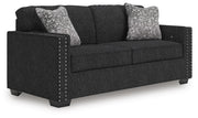 Ashley Furniture Jasmine Peaks sofa showing plush fabric and modern design from an angled view in a living room setting.