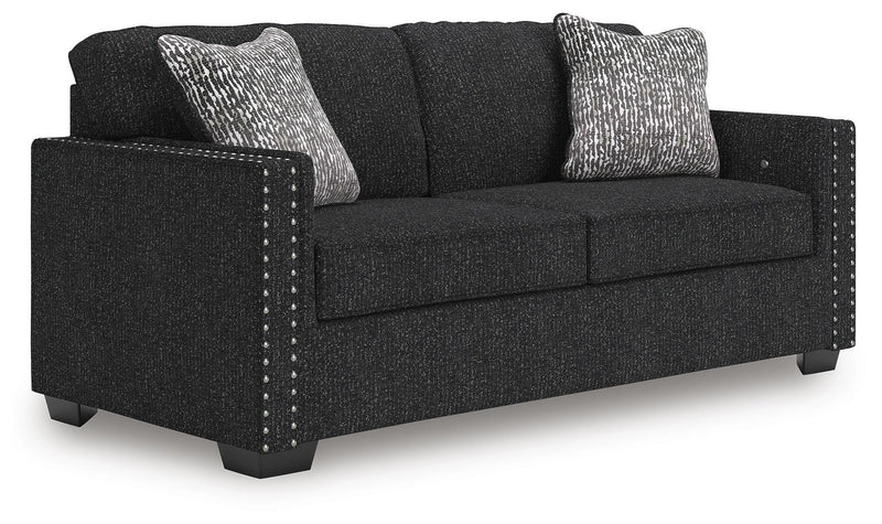 Ashley Furniture Jasmine Peaks sofa showing plush fabric and modern design from an angled view in a living room setting.