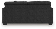 Ashley Furniture Jasmine Peaks sofa with plush cushions, shown from the back in a cozy living room setting.