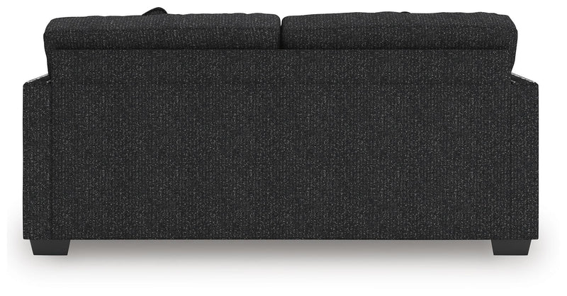 Ashley Furniture Jasmine Peaks sofa with plush cushions, shown from the back in a cozy living room setting.