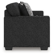 Ashley Furniture Jasmine Peaks sofa showing beige fabric with plush cushions and wooden legs, stylish living room furniture piece.