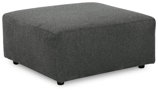 Ashley Furniture Edenfield oversized accent ottoman with plush fabric and wooden legs, shown from an angled view.
