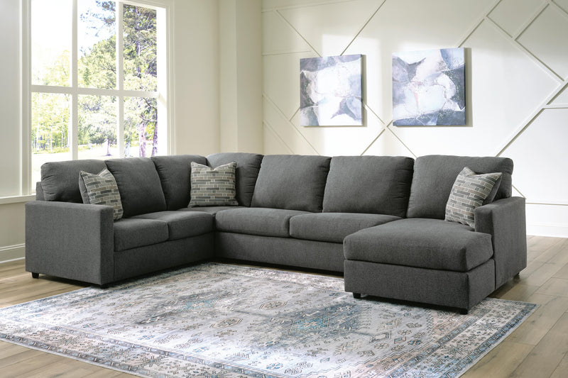 Ashley Furniture Edenfield living room set with a sofa, loveseat, and armchair in beige fabric, arranged in a modern living space.