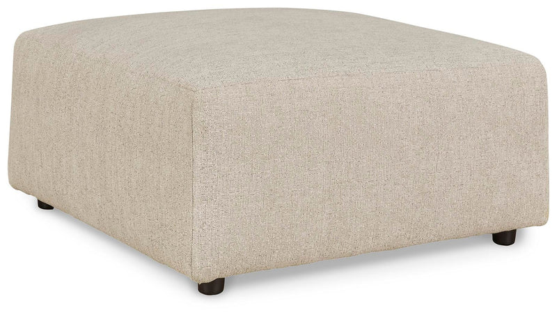 Ashley Furniture Edenfield oversized accent ottoman with plush fabric and tufted top, shown from an angled side view.