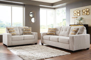 Ashley Furniture Larimer living room set with plush sofa and matching armchair in a modern design, shown in a cozy home setting.