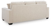Ashley Furniture Larimer sofa with plush cushions and neutral fabric, shown from the back in a well-lit living room setting.