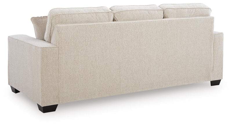 Ashley Furniture Larimer sofa with plush cushions and neutral fabric, shown from the back in a well-lit living room setting.