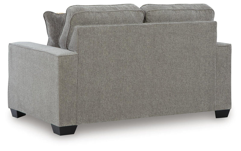 Ashley Furniture Larimer living room set with sofa and armchair, featuring plush cushions and wooden legs in a modern design
