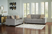 Ashley Furniture Larimer living room set featuring a sofa and loveseat with beige upholstery and decorative pillows.