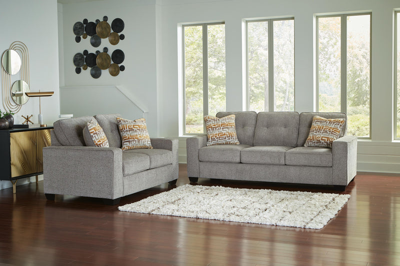 Ashley Furniture Larimer living room set featuring a sofa and loveseat with beige upholstery and decorative pillows.