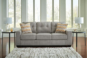 Ashley Furniture Larimer living room set with sofa and loveseat in neutral fabric, arranged in a modern, stylish living space.