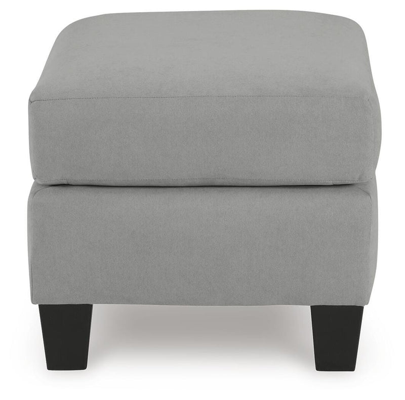 Ashley Furniture Adlai Ottoman showing a plush upholstered surface with wooden legs, ideal for living room decor.