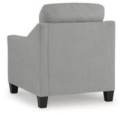 Ashley Furniture Adlai Chair with plush fabric upholstery and wooden legs, shown from the back in a contemporary living room setting.