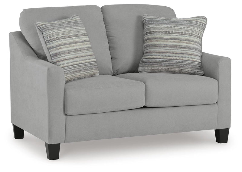 Ashley Furniture Adlai loveseat in beige fabric, angled view showing plush cushions and stylish wooden legs.