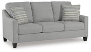 Ashley Furniture Adlai sofa shown from an angled view, featuring plush cushions and modern design in a neutral fabric.