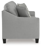 Ashley Furniture Adlai sofa with beige upholstery, showing plush cushions and side view of modern living room furniture.