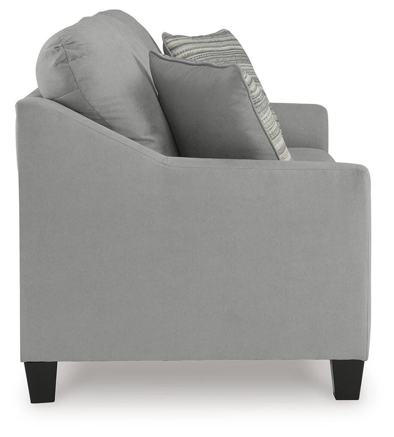 Ashley Furniture Adlai sofa with beige upholstery, showing plush cushions and side view of modern living room furniture.