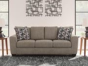 Ashley Furniture Triston-Peaks sofa with plush fabric and cushioned armrests in a modern living room setting.
