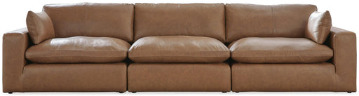 Ashley Furniture Emilia sectional sofa with plush cushions and modern design, shown in a spacious living room setting.