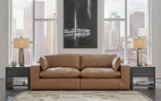 Ashley Furniture Emilia Sectional Loveseat with plush cushions and modern design, shown in a cozy living room setting.