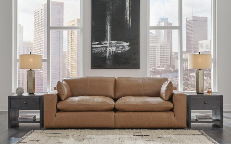 Ashley Furniture Emilia 2-Piece Sectional Loveseat showing plush fabric cushions and modern design with neutral upholstery.