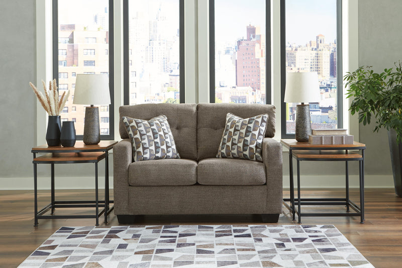 Ashley Furniture Mahoney living room set with sofa, loveseat, and armchair arranged in a modern design with neutral upholstery.