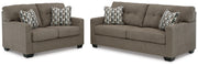 Ashley Furniture Mahoney living room set featuring a sofa and matching armchair with neutral fabric upholstery.