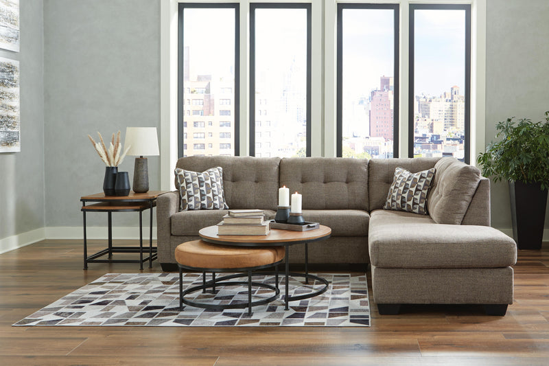 Ashley Furniture Mahoney 2-Piece sectional with chaise, showcasing plush fabric and modern design in a cozy living room setting.