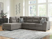 Ashley Furniture Olten sectional with chaise, showing plush fabric upholstery and modern design in a spacious living room setting.