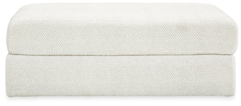 Ashley Furniture Karinne oversized accent ottoman with plush fabric and tufted top, shown in a neutral color.