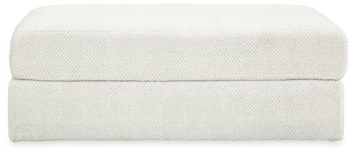 Ashley Furniture Karinne oversized accent ottoman with plush fabric and tufted top, shown in a neutral color.