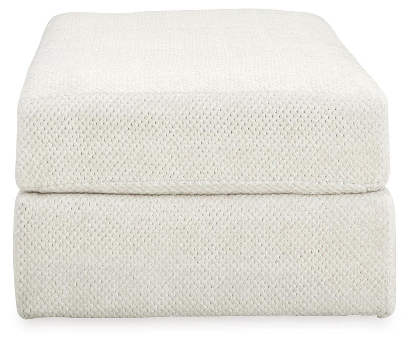 Ashley Furniture Karinne oversized accent ottoman with soft fabric upholstery, featuring a plush, rectangular design for stylish comfort.