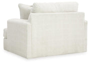 Oversized Ashley Furniture Karinne chair with plush fabric and wide armrests, shown from the back in a modern living room setting.