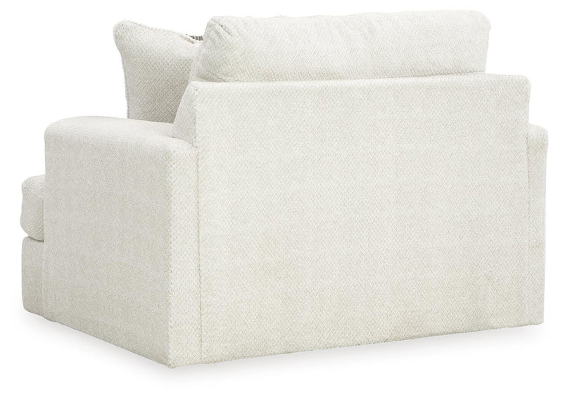 Oversized Ashley Furniture Karinne chair with plush fabric and wide armrests, shown from the back in a modern living room setting.