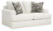Ashley Furniture Karinne Loveseat with plush fabric and modern design, shown from an angled side view.