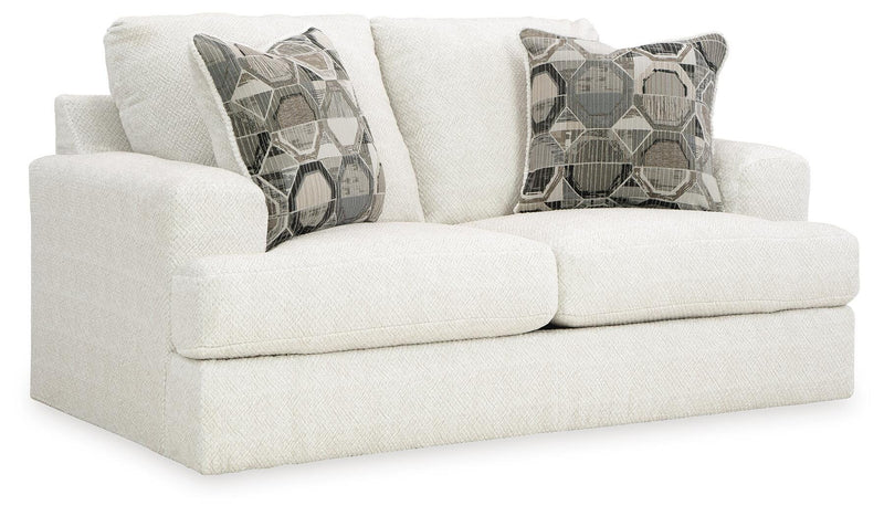 Ashley Furniture Karinne Loveseat with plush fabric and modern design, shown from an angled side view.