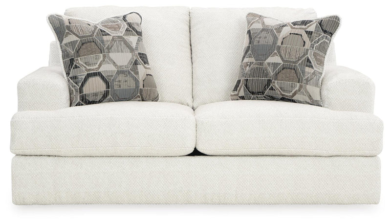 Ashley Furniture Karinne Loveseat with plush fabric and cushioned backrest, shown from a head-on view.
